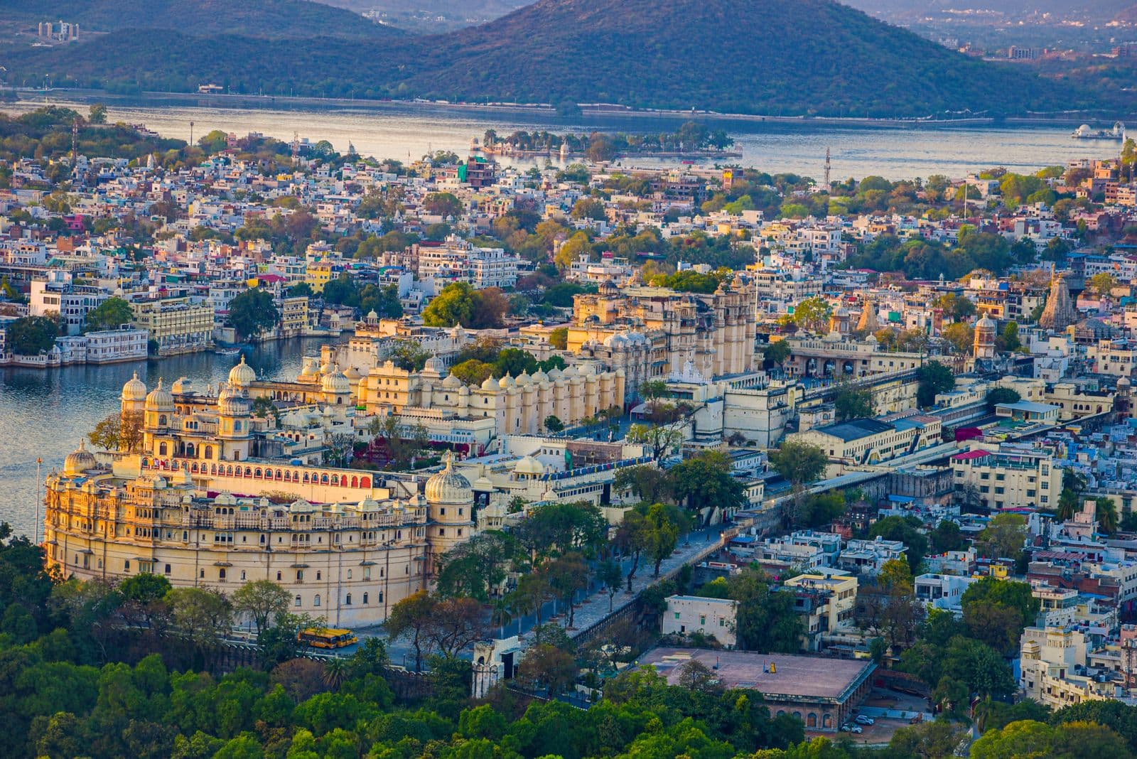 An aerial view of Udaipur City Palace and the surrounding lakeside city.